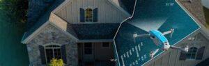 A drone capturing an aerial view of a house with a new shingle roof.