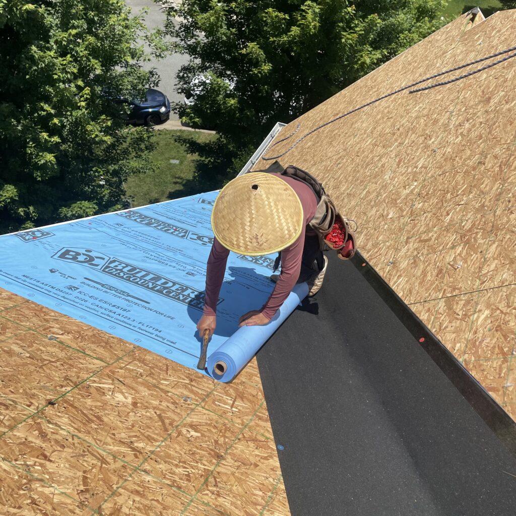 MCSquared Roofing crew installing underlayment on a North Carolina roof