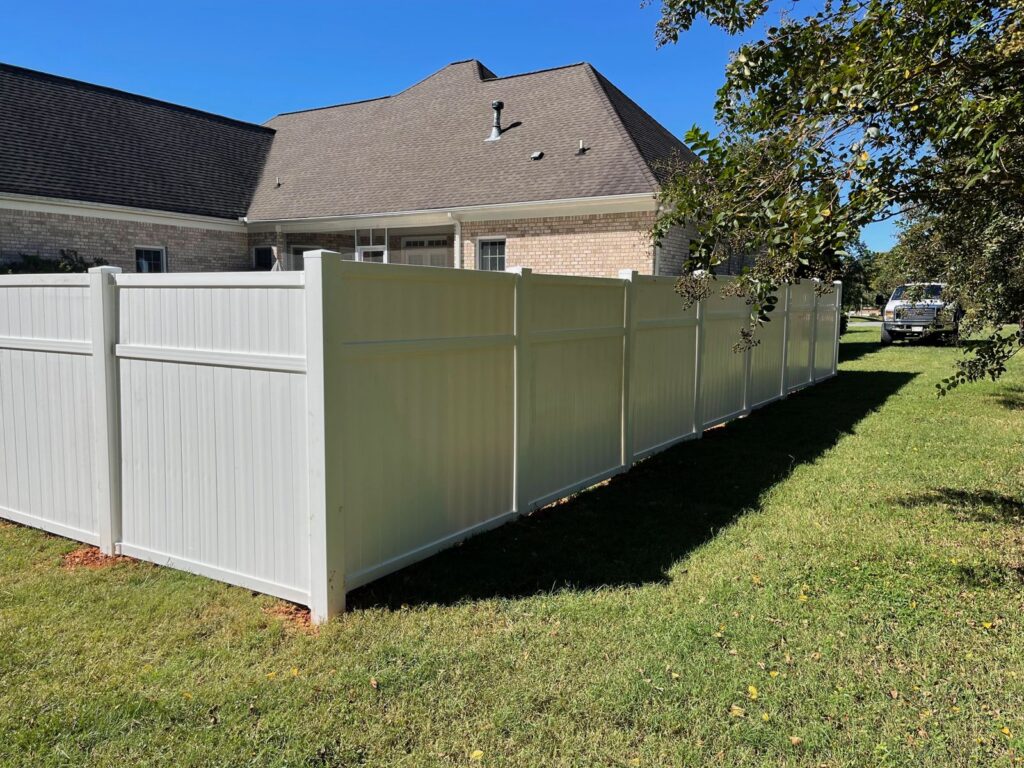 MCSquared Roofing white vinyl privacy fence installed with company truck, Burlington NC