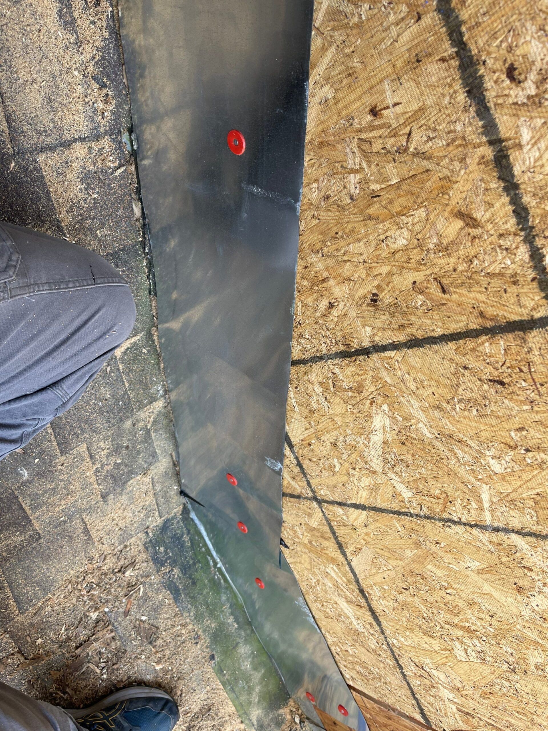 MCSquared Roofing installer securing roof flashing with proper fastener spacing