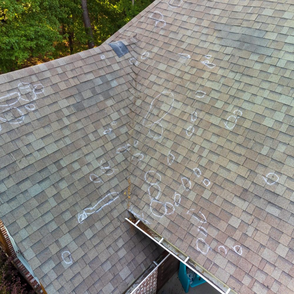 Roof with hail damage and markings from inspection Hail damaged roof